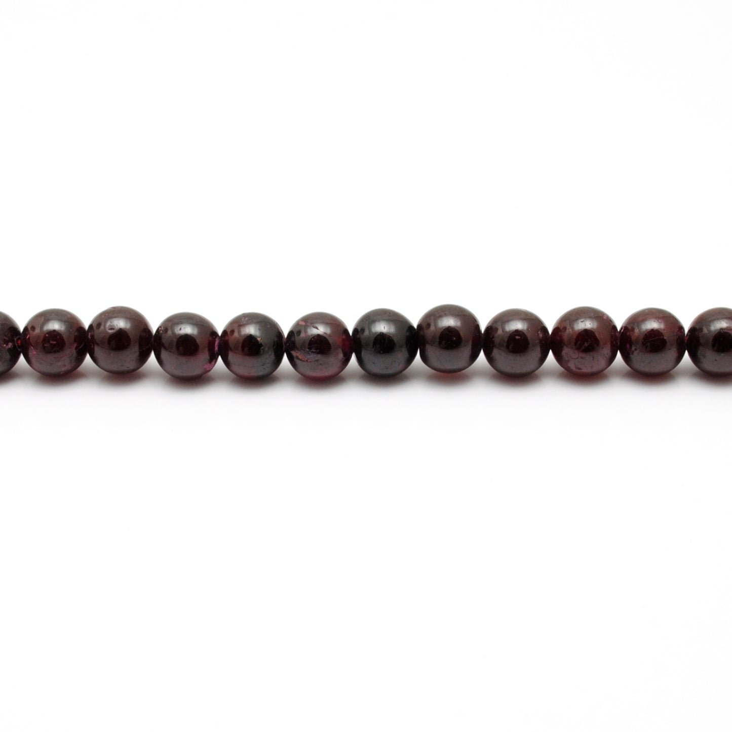 Rhodolite garnet round beads 16 inch strand - overhead flat lay
