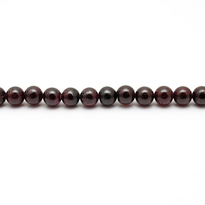 Rhodolite garnet round beads 16 inch strand - overhead flat lay