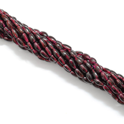 Rhodolite garnet drum beads 16 inch strand - overhead flat lay