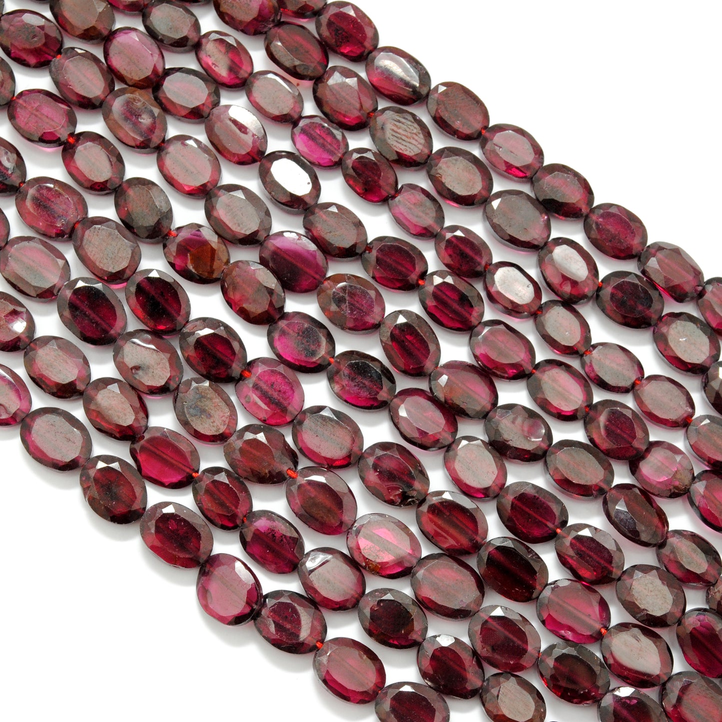 Rhodolite garnet oval faceted beads 17 inch strand overhead flat lay