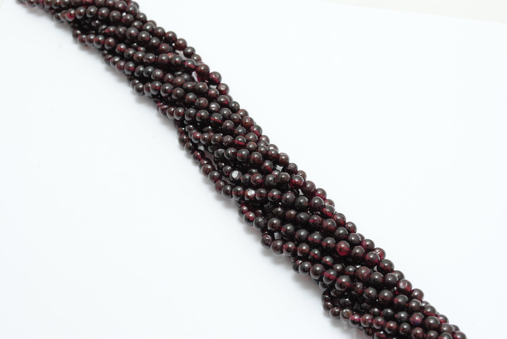 Rhodolite garnet 5.5-6mm round beads 14 inch strand - overhead flat lay