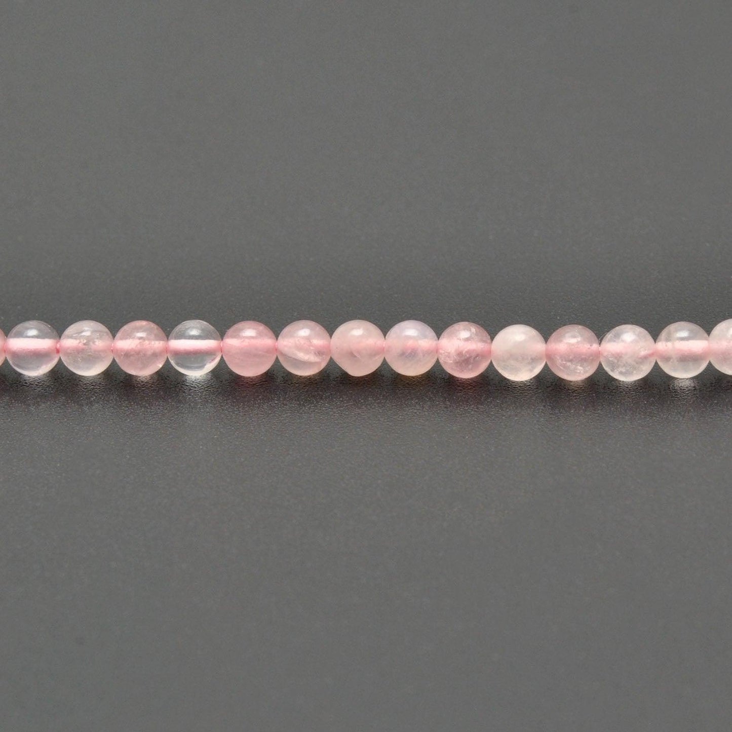 Rose quartz round beads strand overhead flat lay