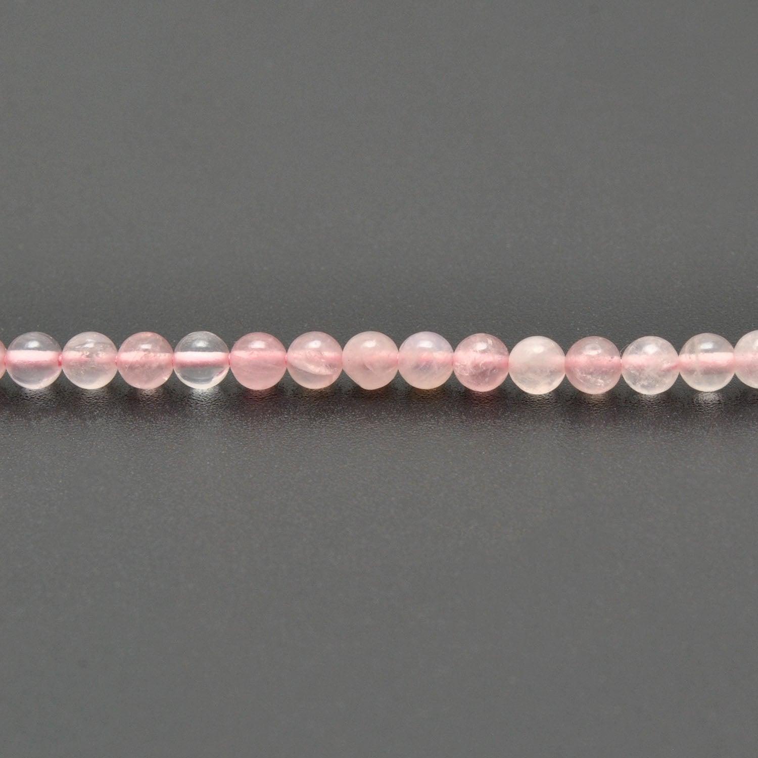 Rose quartz round beads strand overhead flat lay