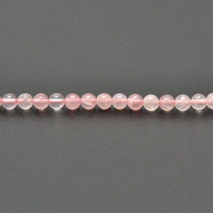 Rose quartz round beads strand overhead flat lay