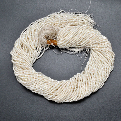 White shell pearl round beads 16 inch strand overhead flat lay