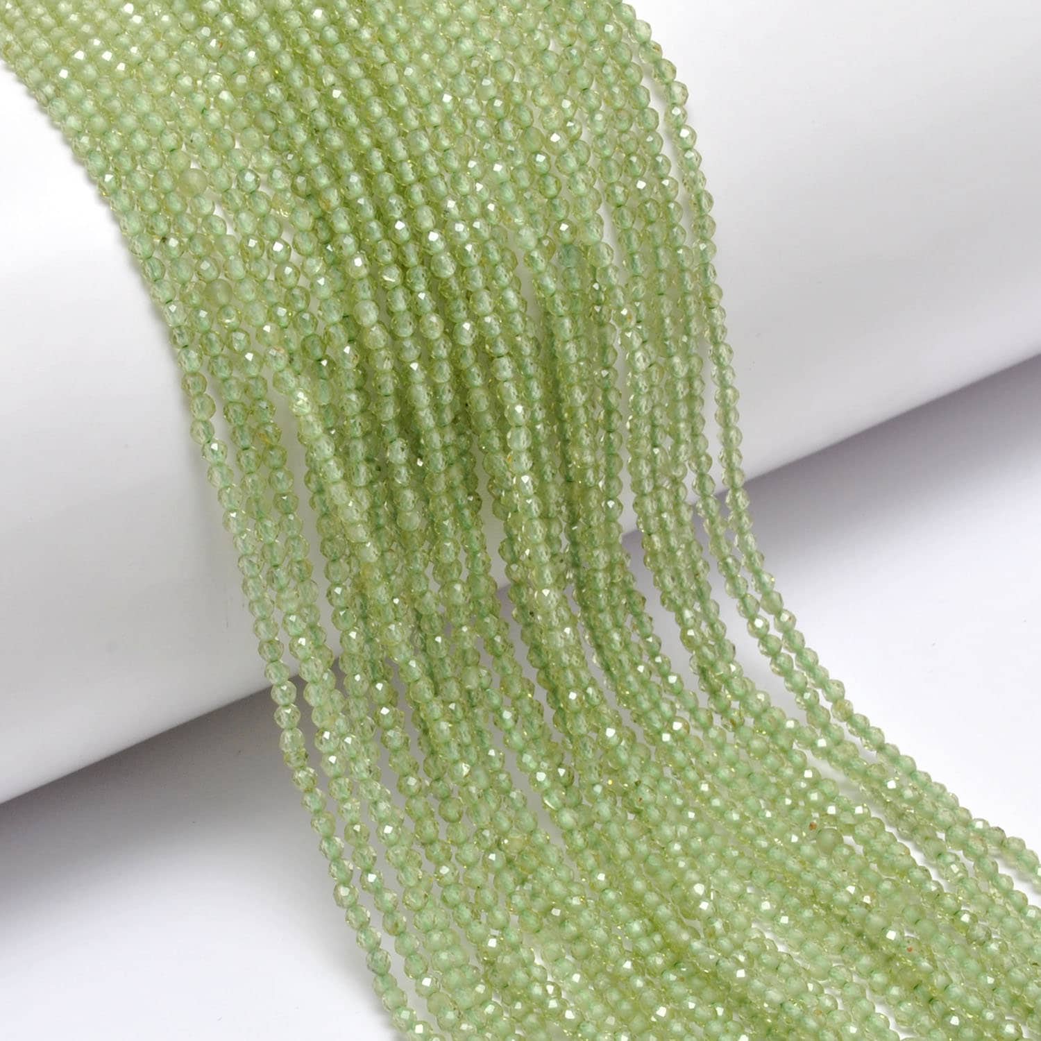 Peridot round faceted beads - close-up vivid lime-green sparkle