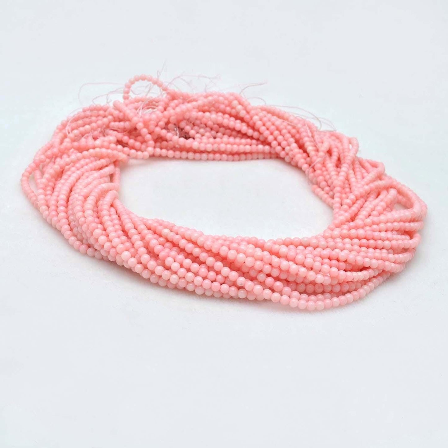 Pink coral plain round gemstone beads 12.5 inch strand - front view