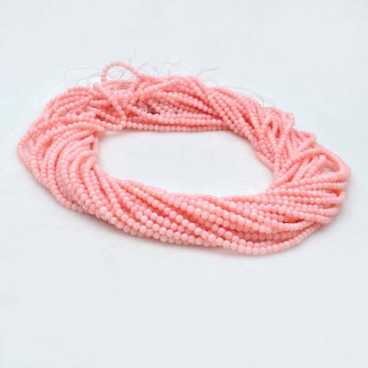 Pink coral plain round gemstone beads 12.5 inch strand - front view
