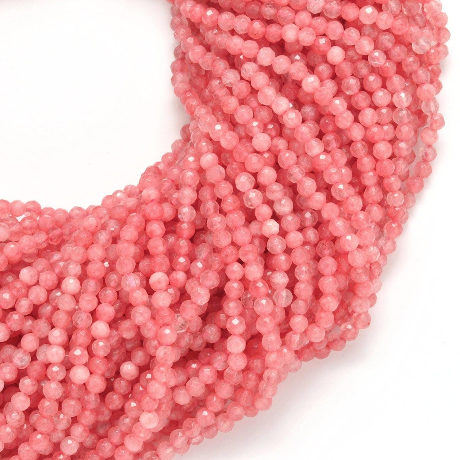 Pink quartz small faceted round beads close-up delicate pink colour