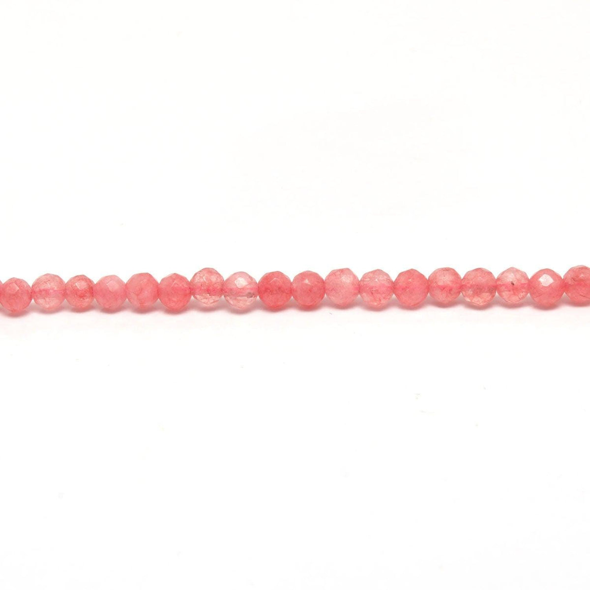 Pink quartz faceted round beads scattered loose view