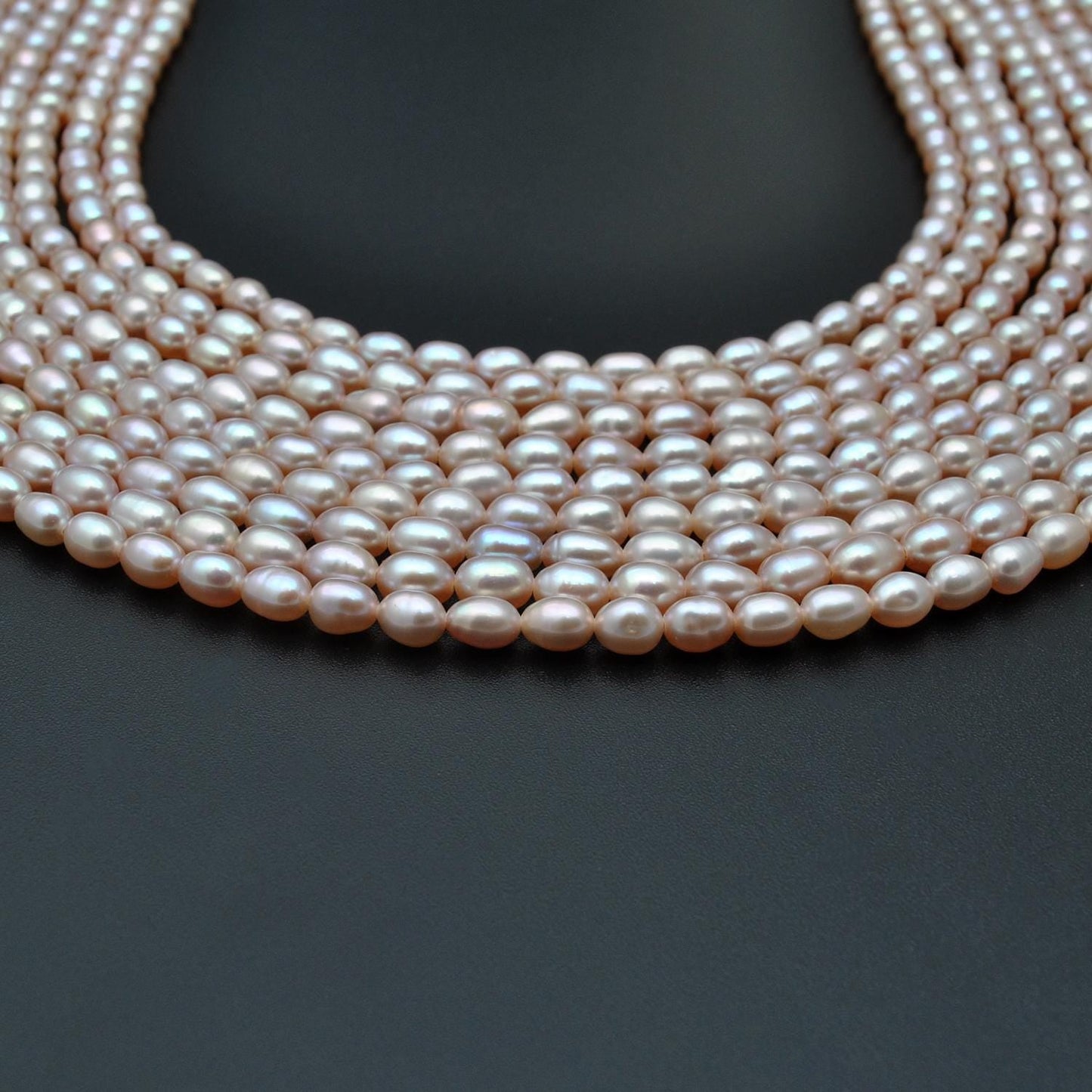 Pink rice pearl oval beads - close-up rose lustre delicate detail