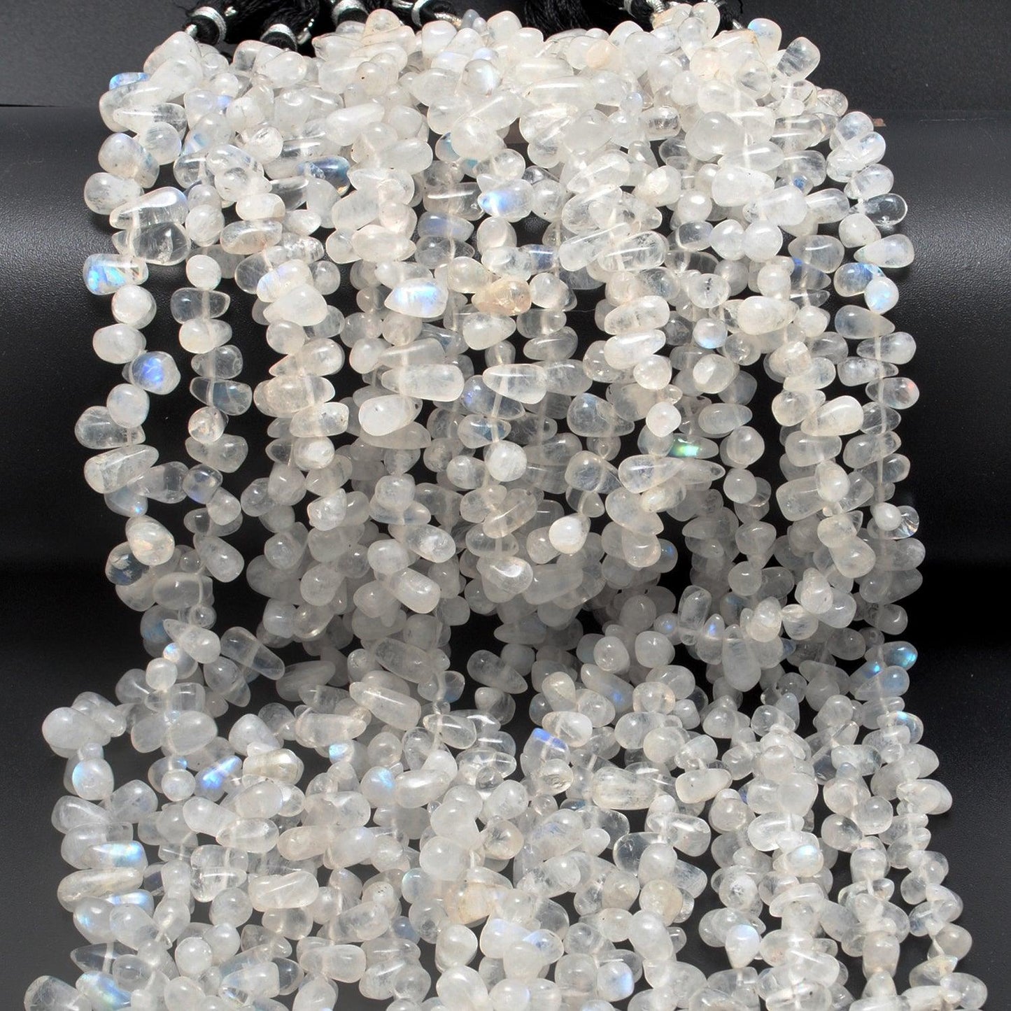 Rainbow moonstone drop beads close-up ethereal blue adularescence glow