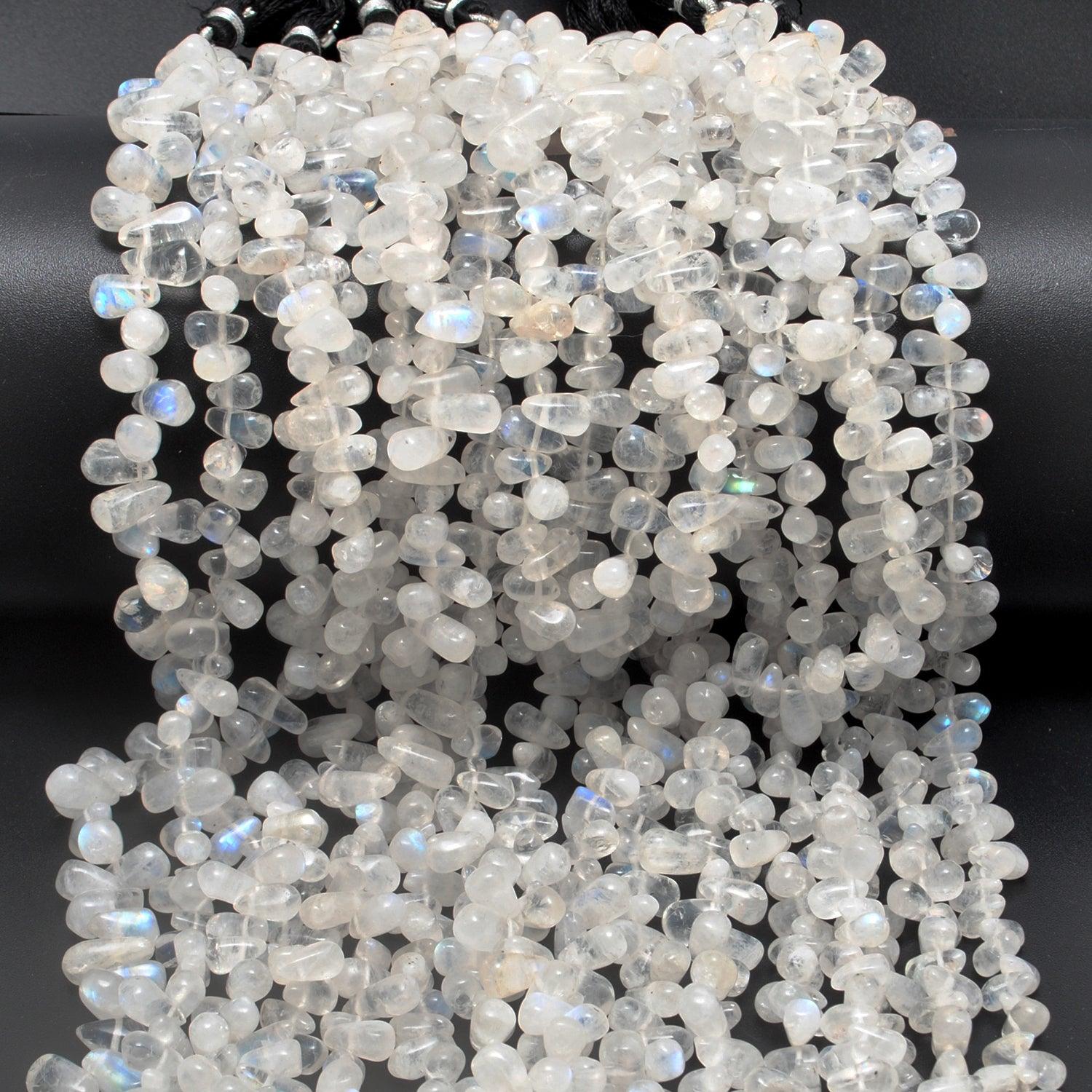 Rainbow moonstone drop beads close-up ethereal blue adularescence glow