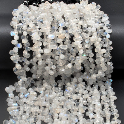 Rainbow moonstone drop beads close-up ethereal blue adularescence glow