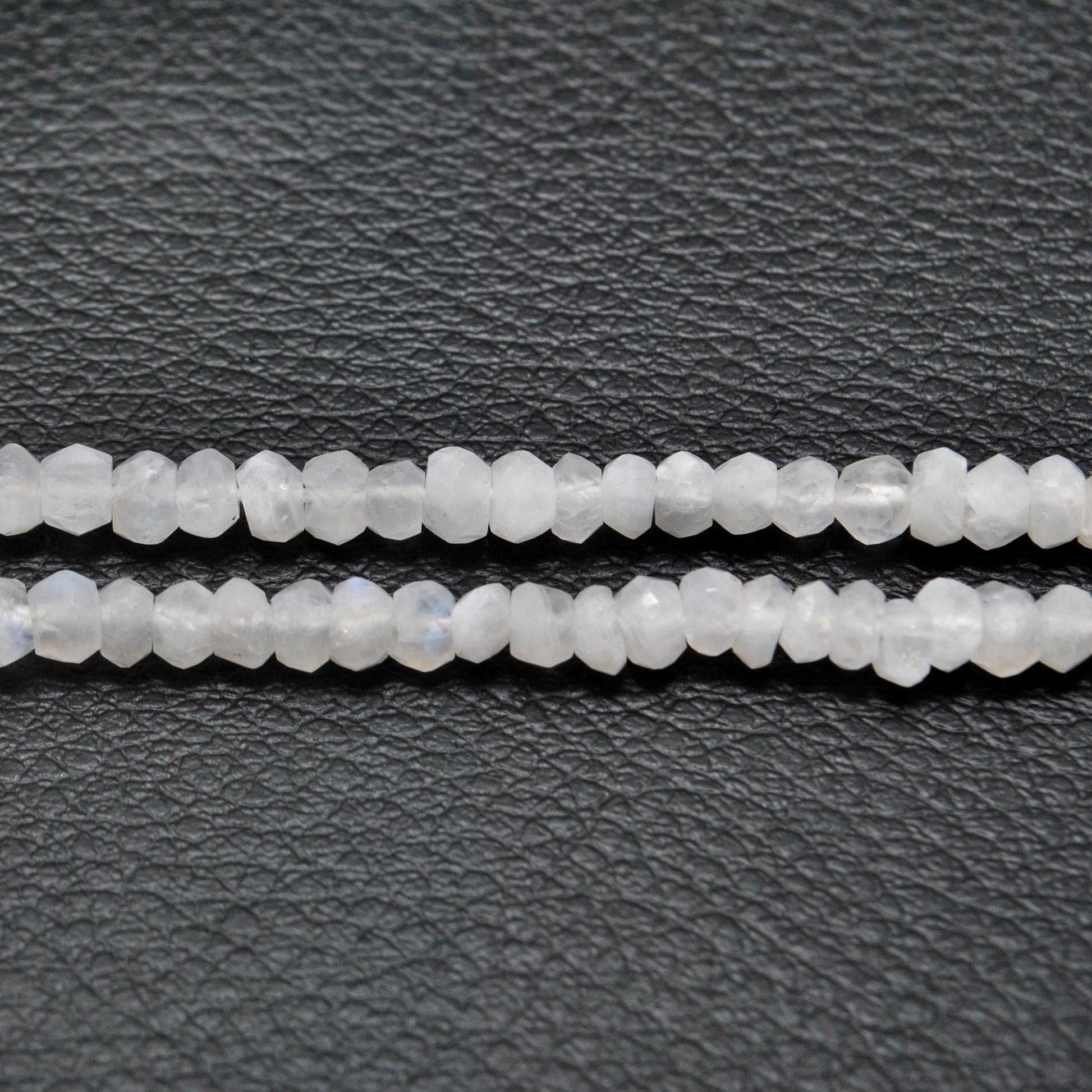 Rainbow moonstone rondelle beads - close-up electric blue flash