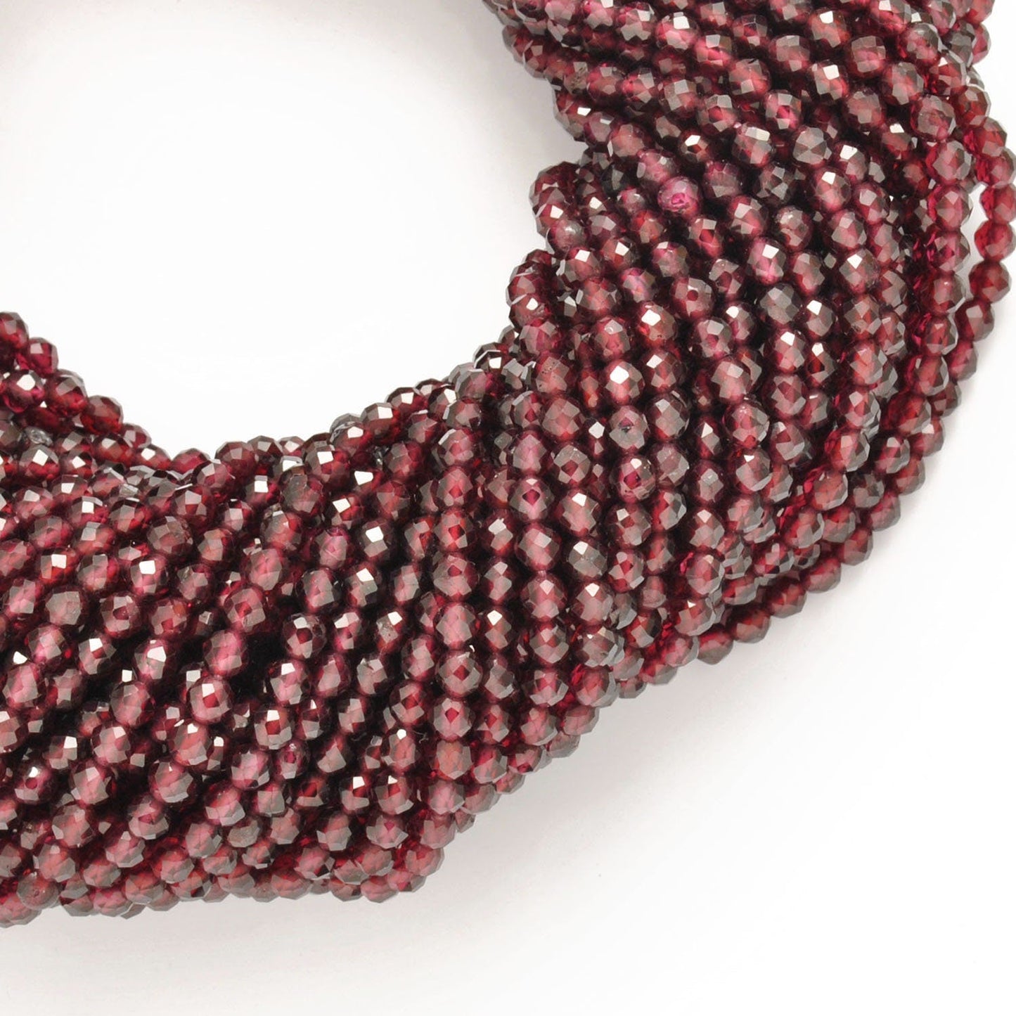 Red garnet faceted round beads close-up deep crimson colour