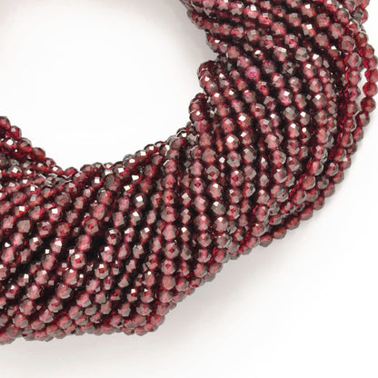 Red garnet faceted round beads close-up deep crimson colour