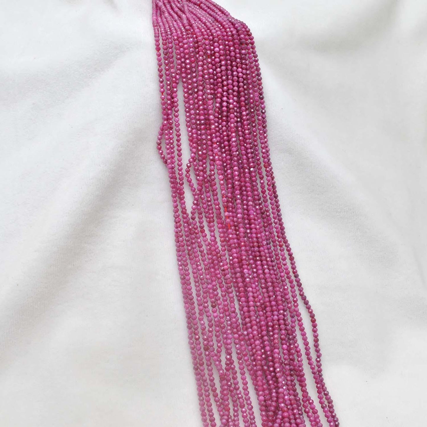 Red moonstone faceted beads scattered loose - rare peach-red view