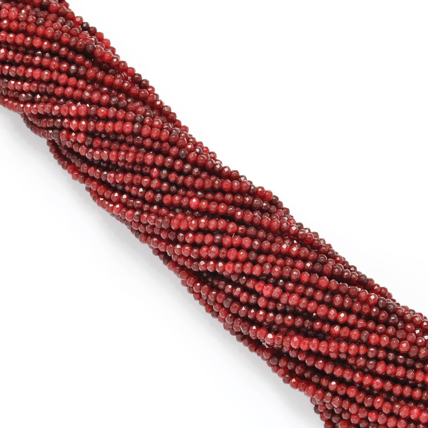 Red ruby faceted rondelle beads scattered loose view Jaipur