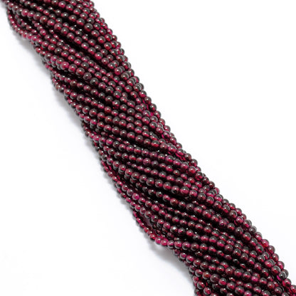 Rhodolite garnet 5.5-6mm beads detail shot - pink-red colour