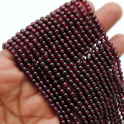 Rhodolite garnet 5.5-6mm round beads - close-up luster detail