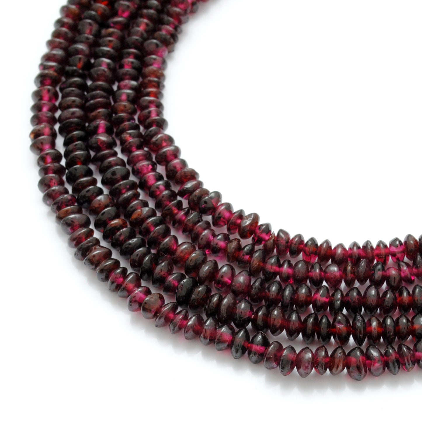 Rhodolite garnet button beads close-up pinkish-red flat shape