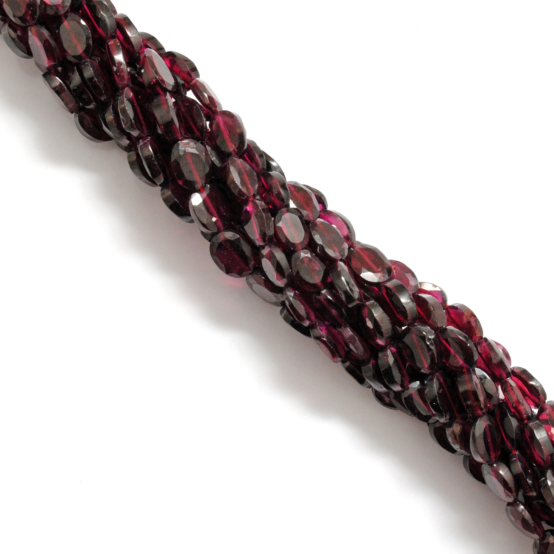 Rhodolite garnet faceted oval beads scattered loose 5x7-6x8mm view