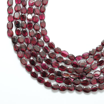 Rhodolite garnet faceted oval beads close-up vivid pinkish-red