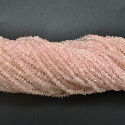 Rose quartz button beads scattered loose - flat button shape view