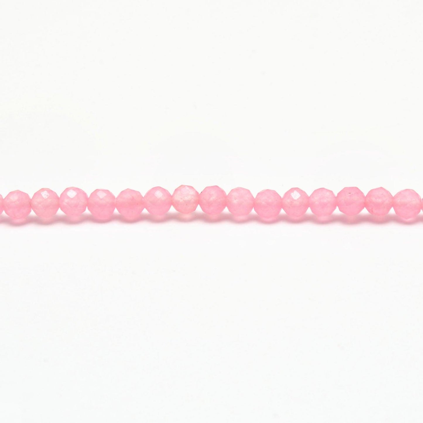 Rose quartz faceted round beads scattered loose view