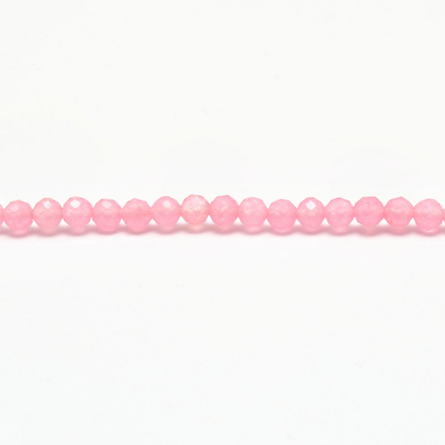 Rose quartz faceted round beads scattered loose view