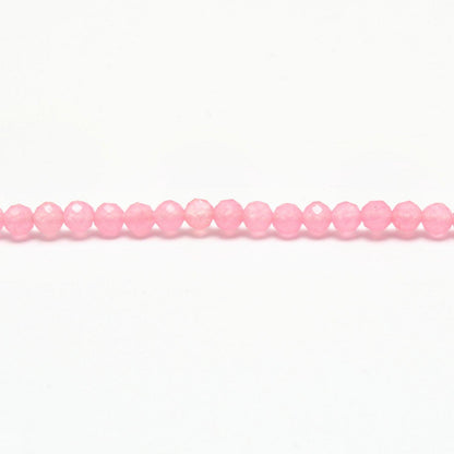 Rose quartz faceted round beads scattered loose view