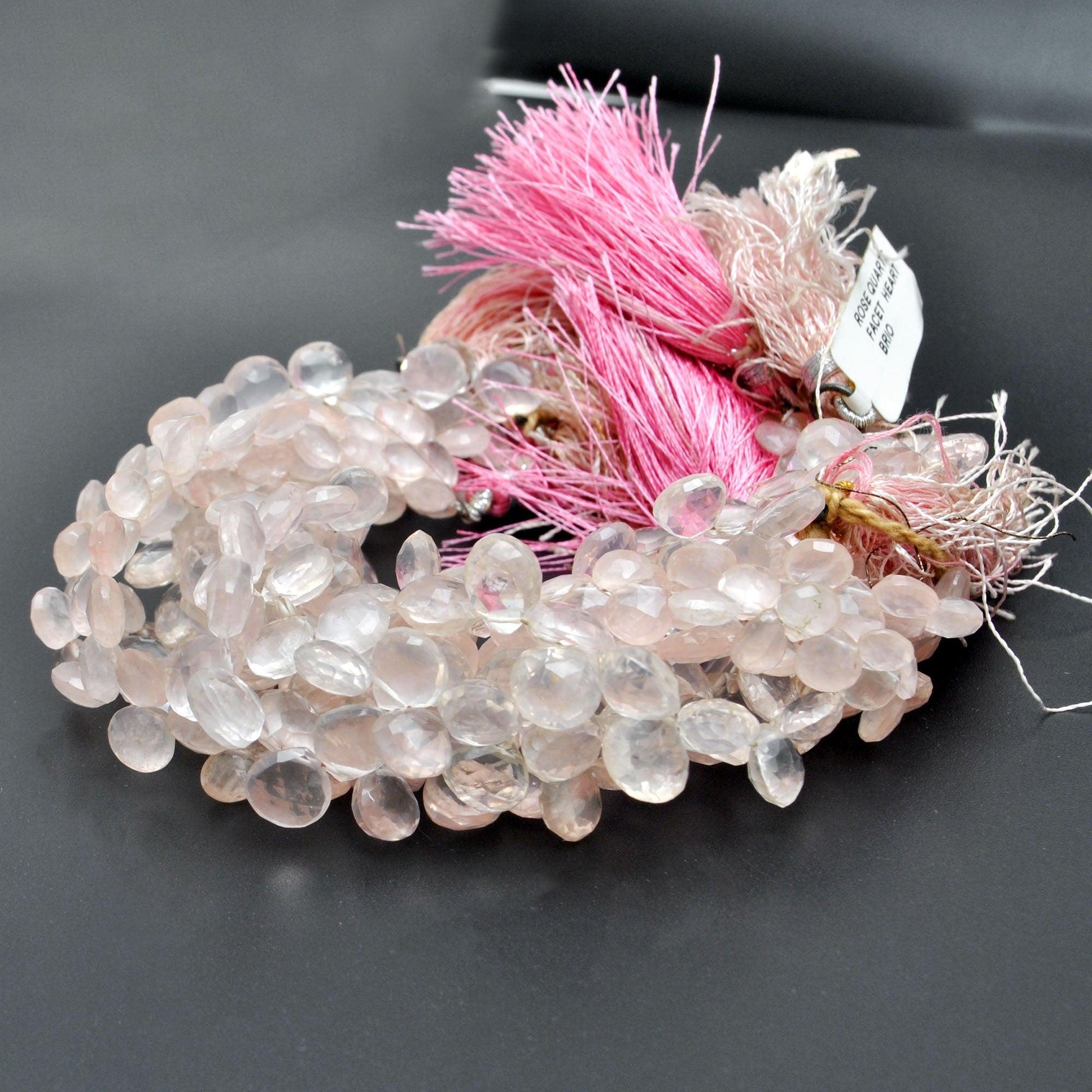 Rose quartz heart beads scattered loose - 8mm faceted heart shape view