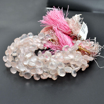 Rose quartz heart beads scattered loose - 8mm faceted heart shape view