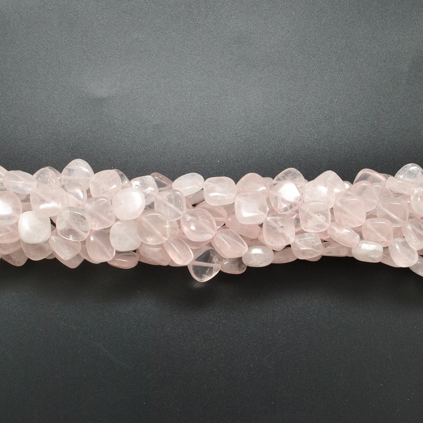 Rose quartz cushion beads scattered loose - cushion shape view