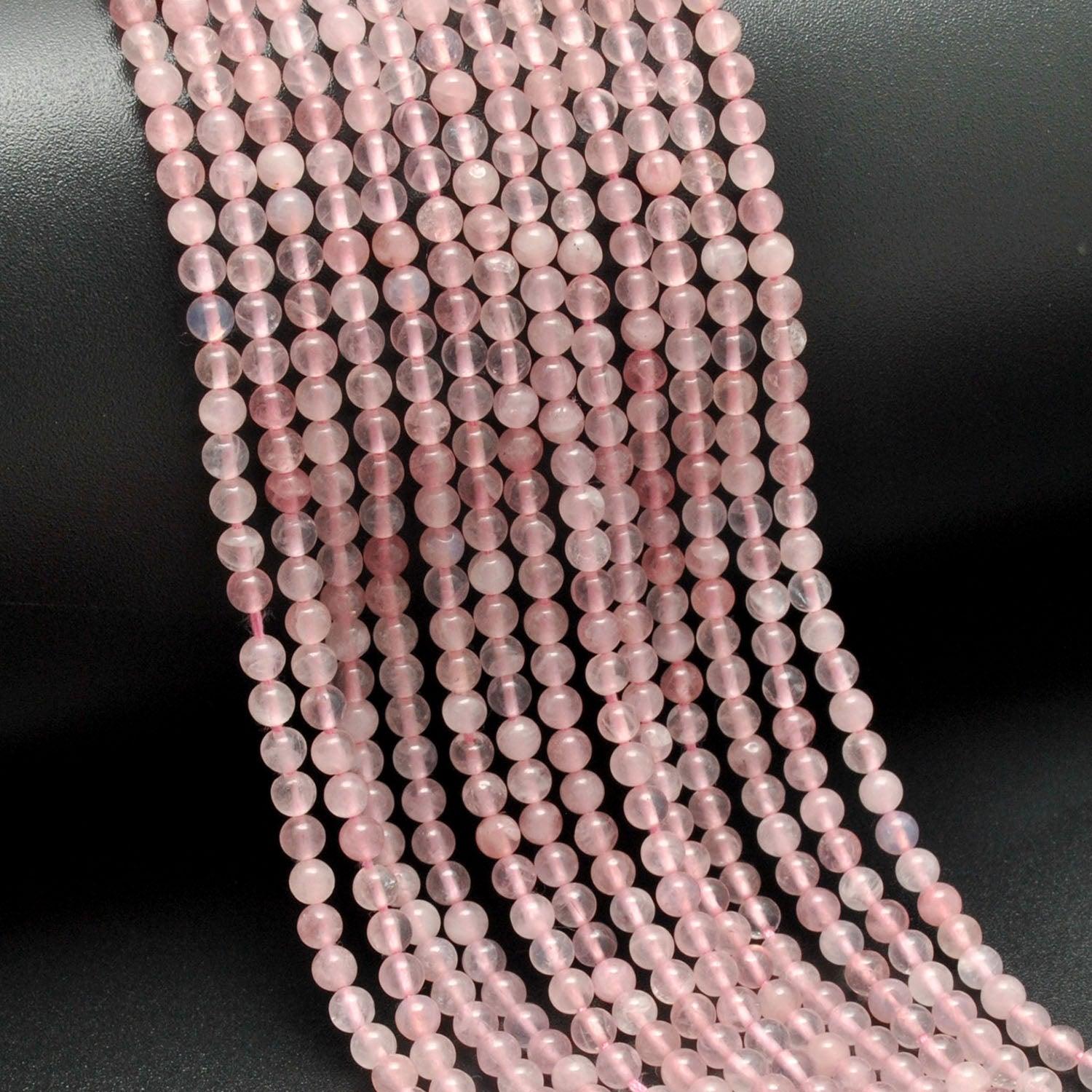 Rose quartz plain round beads close-up smooth blush-pink colour