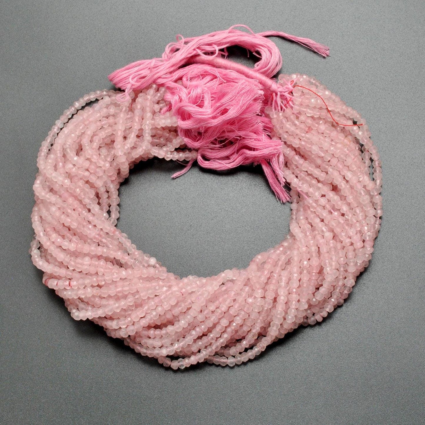 Rose quartz rondelle faceted beads close-up soft pink sparkle