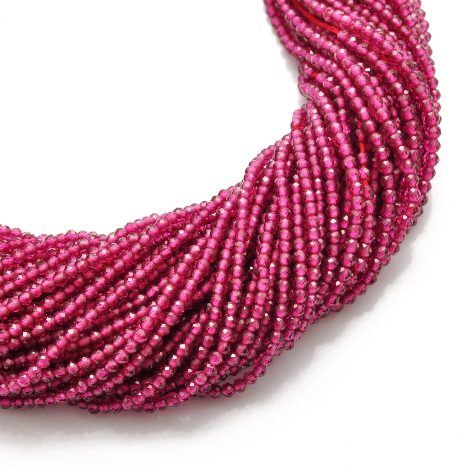 Ruby corundum faceted round beads scattered loose view Jaipur