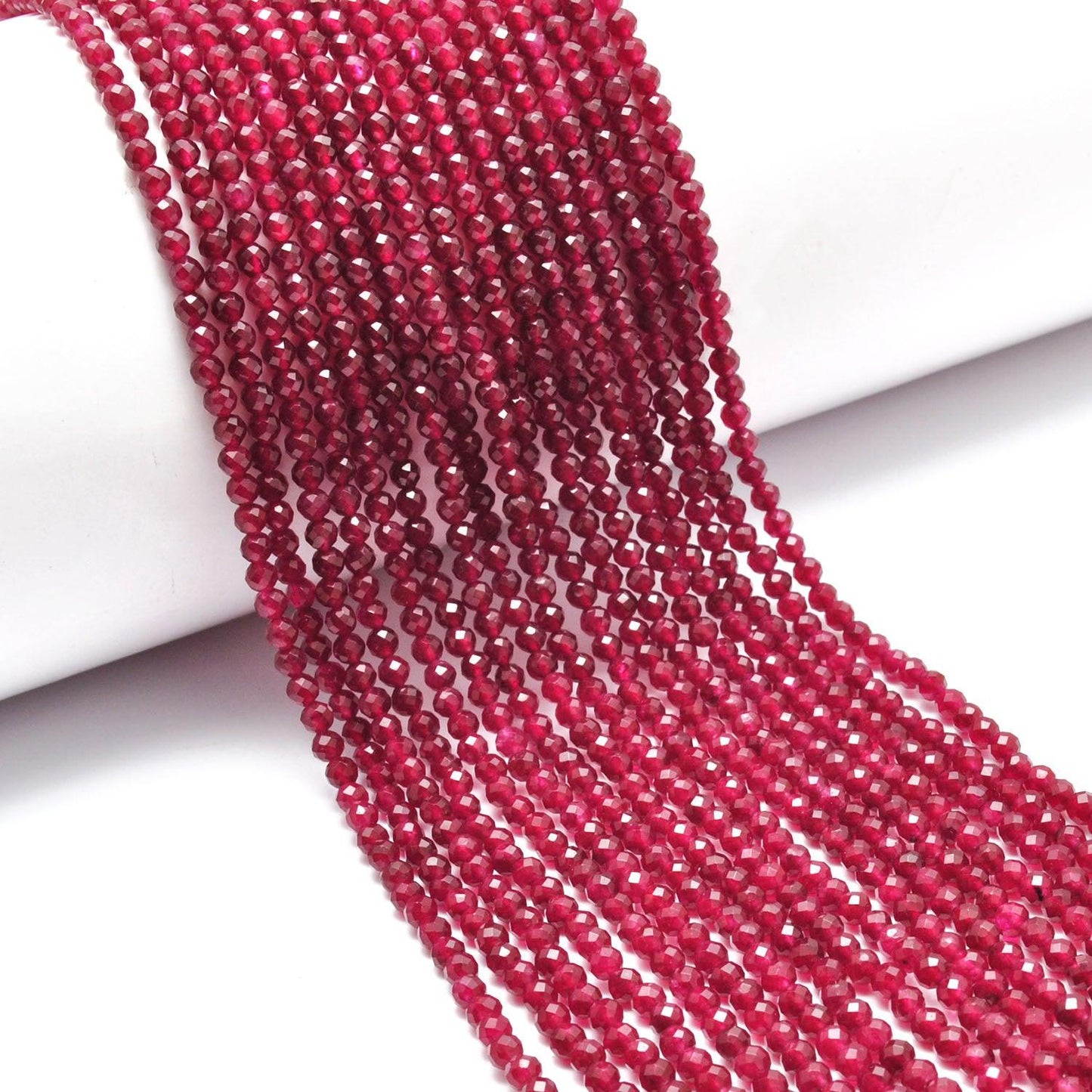 Ruby quartz round faceted beads close-up vibrant ruby-red colour