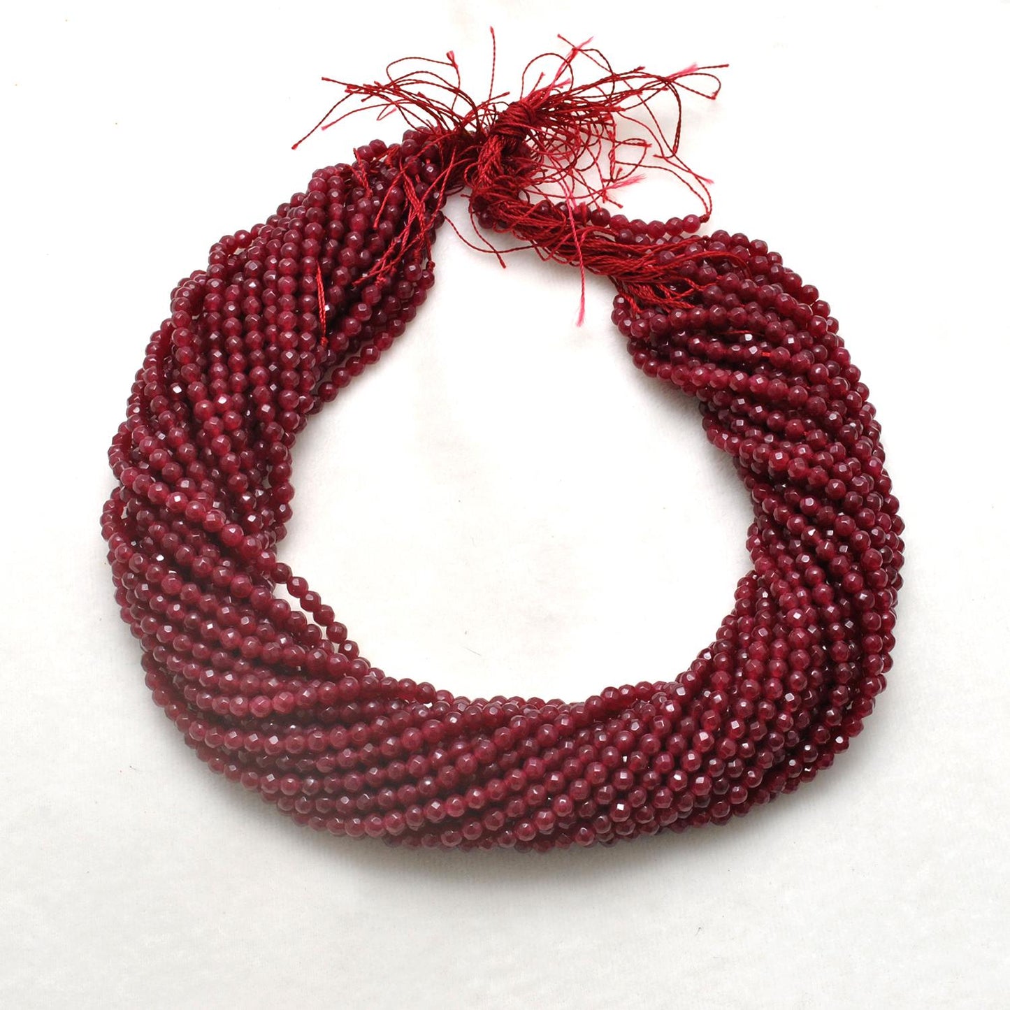 Ruby quartz faceted round beads close-up vibrant ruby-red colour