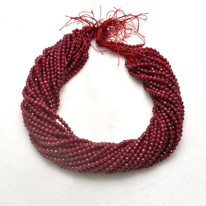 Ruby quartz faceted round beads close-up vibrant ruby-red colour