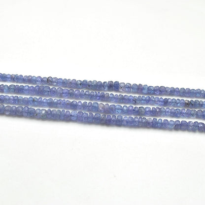 Tanzanite rondelle beads scattered loose - rare violet-blue view
