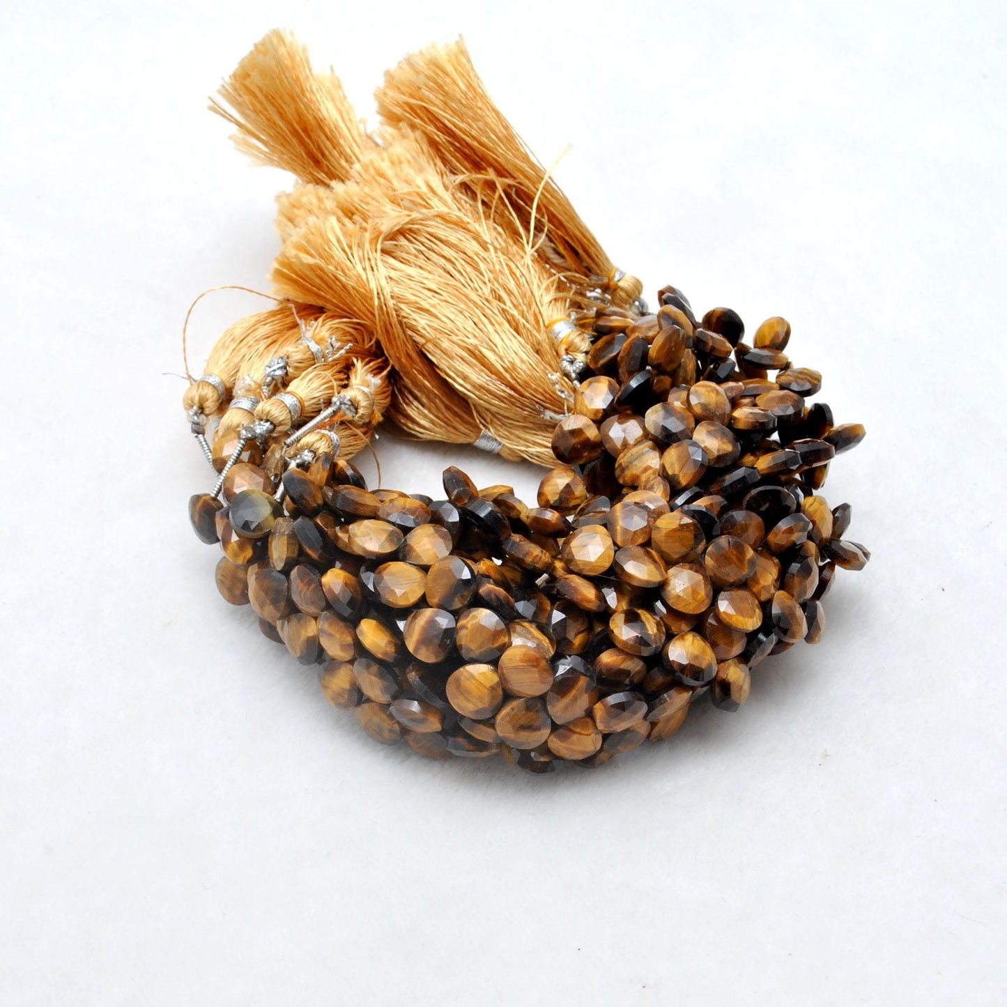 Tiger eye faceted heart beads scattered loose - heart shape view