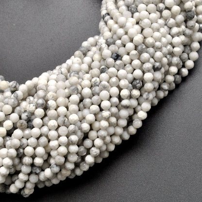 White howlite faceted round beads close-up chalk-white grey veining