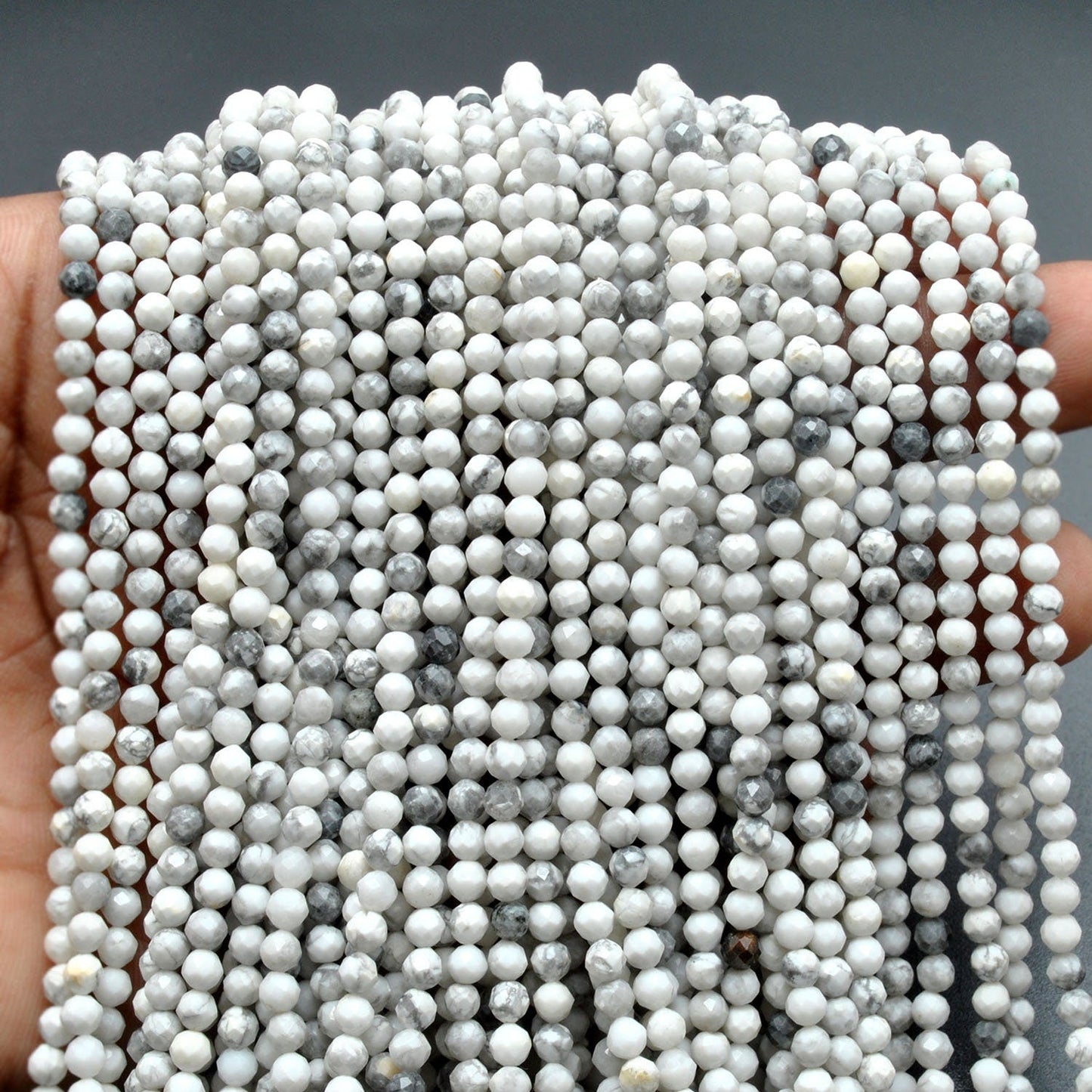 White howlite faceted round beads scattered loose view Jaipur