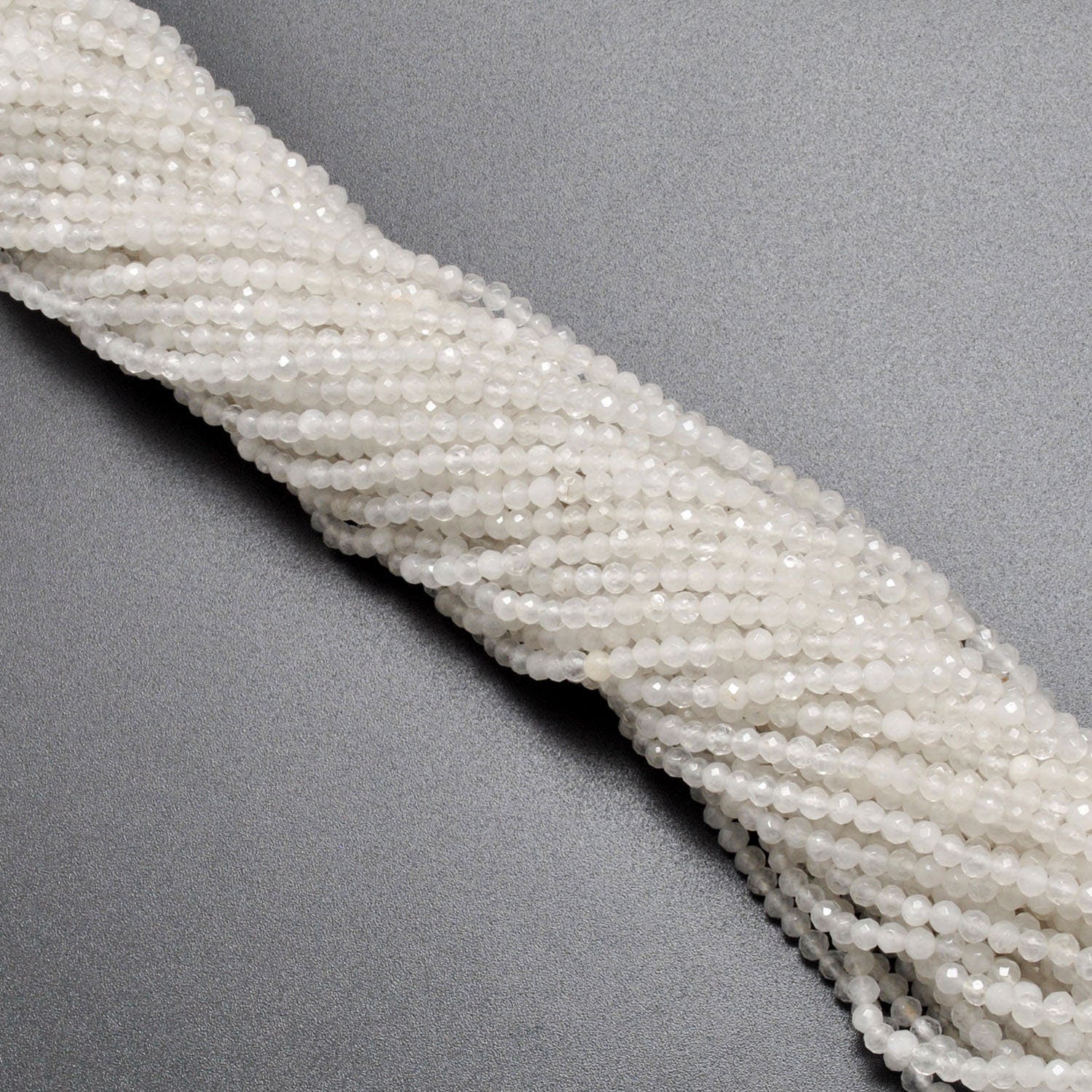 White quartz round beads scattered loose - faceted shape view